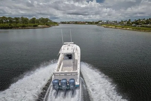 Slide: The Image of Overhead view of 2015 Invincible 36 boat with triple engines on water. - 50