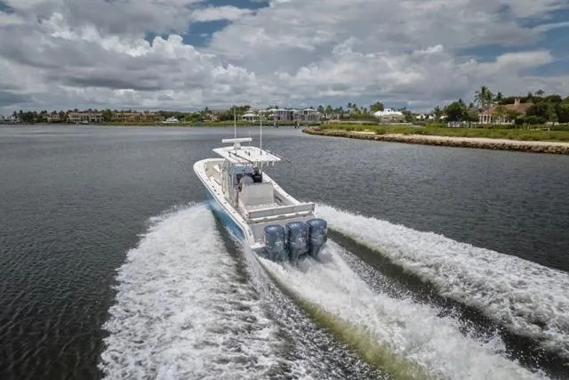 Slide: The Image of Invincible 36 boat cruising on a river, 2015 model, with triple outboard engines. - 51