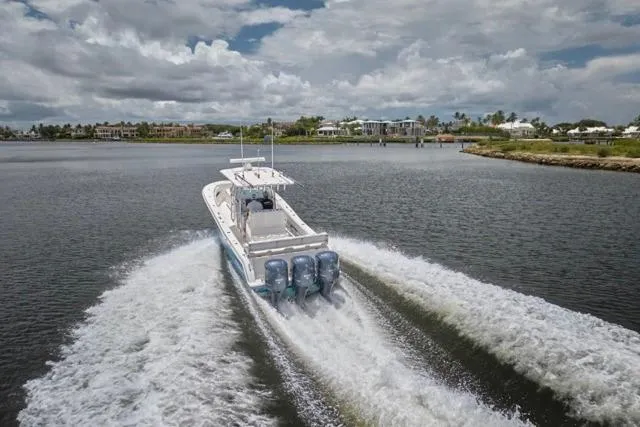 Slide: The Image of Invincible 36 boat cruising on water, 2015 model, with three powerful engines. - 52