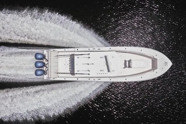 Slide: The Image of Overhead view of 2015 Invincible 36 boat cruising on water. - 56