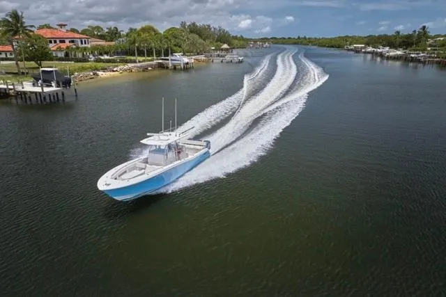 Slide: The Image of Invincible 36 boat cruising on a scenic waterway, 2015 model. - 58