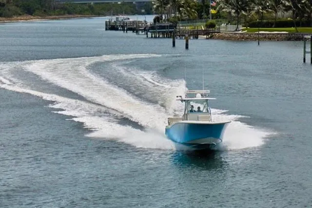 Slide: The Image of Invincible 36 boat cruising on a scenic waterway, 2015 model. - 61