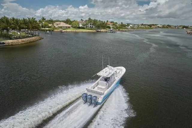 Slide: The Image of Invincible 36 boat cruising on a scenic waterway, 2015 model, with powerful engines. - 67