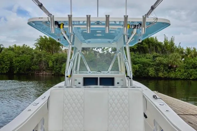 Slide: The Image of 2015 Invincible 36 boat docked, featuring spacious seating and sleek design. - 7