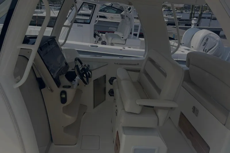 Slide: The Image of Interior view of 2020 Boston Whaler 350 Realm boat cockpit with seating and controls. - 11