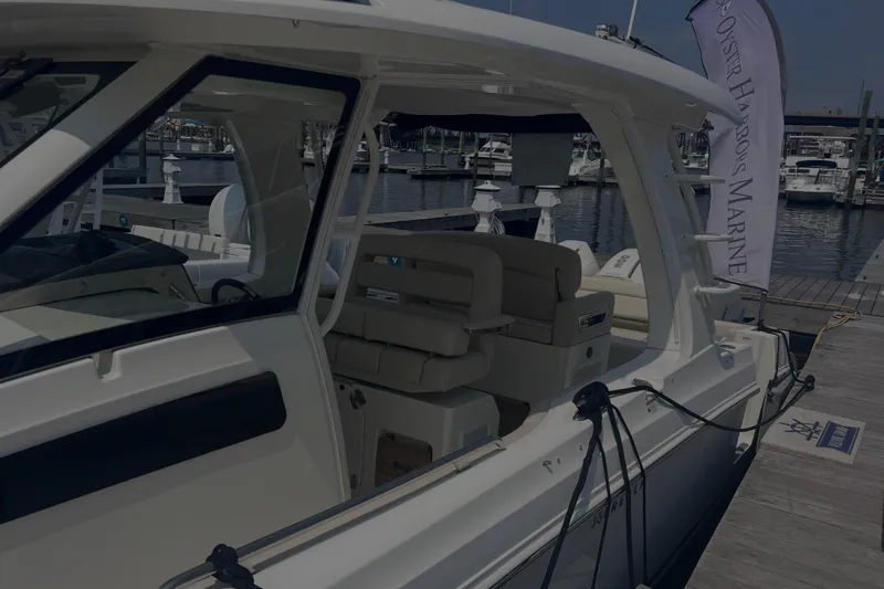 Slide: The Image of 2020 Boston Whaler 350 Realm docked at marina, showcasing sleek design and luxury seating. - 14