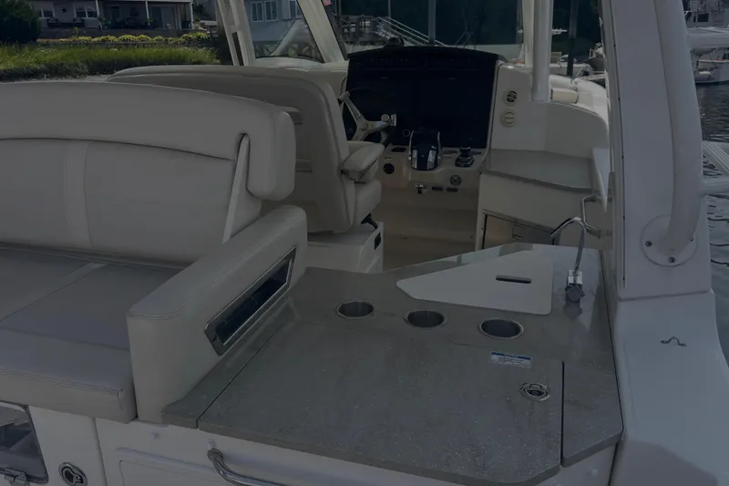 Slide: The Image of 2020 Boston Whaler 350 Realm interior with seating and helm station. - 15