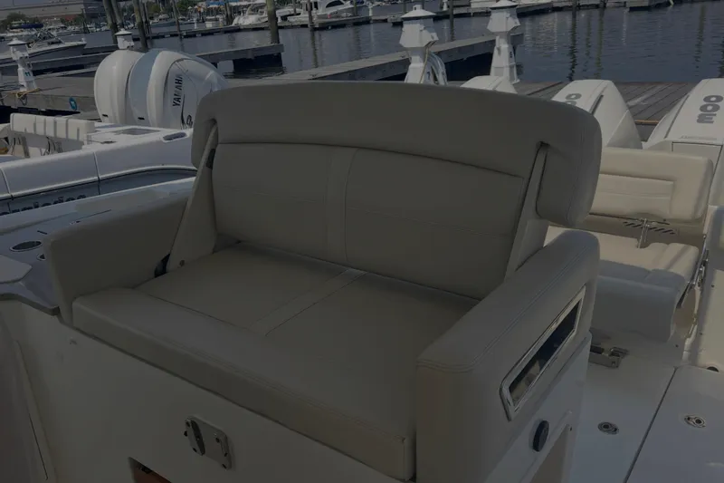Slide: The Image of 2020 Boston Whaler 350 Realm boat seating area at marina dock. - 16