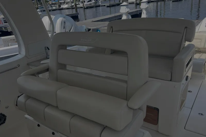 Slide: The Image of Interior seating of a 2020 Boston Whaler 350 Realm boat at a marina. - 17