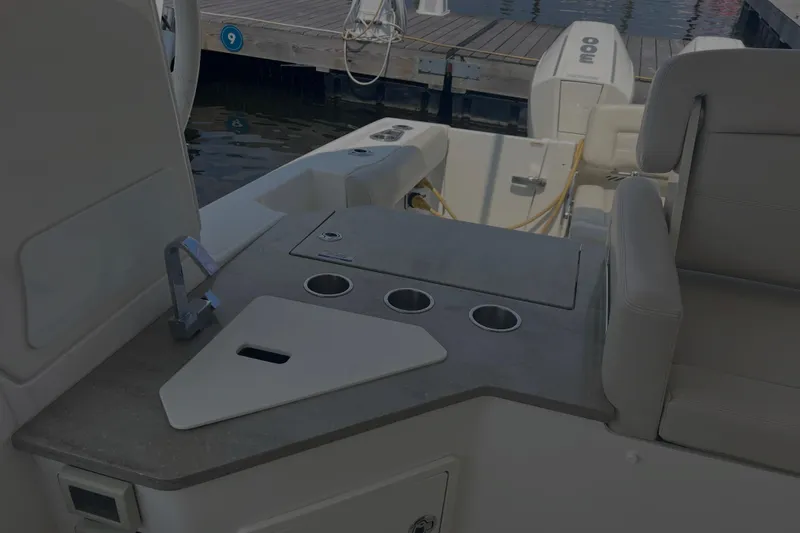 Slide: The Image of 2020 Boston Whaler 350 Realm boat interior with seating and utility area. - 18