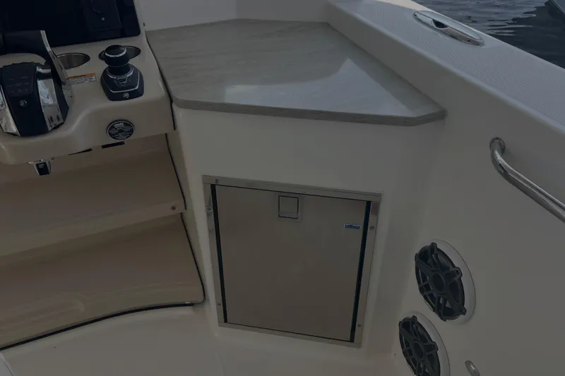 Slide: The Image of Interior of 2020 Boston Whaler 350 Realm boat with control panel and storage. - 20