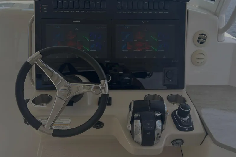 Slide: The Image of Control panel of 2020 Boston Whaler 350 Realm with steering wheel and navigation screens. - 21