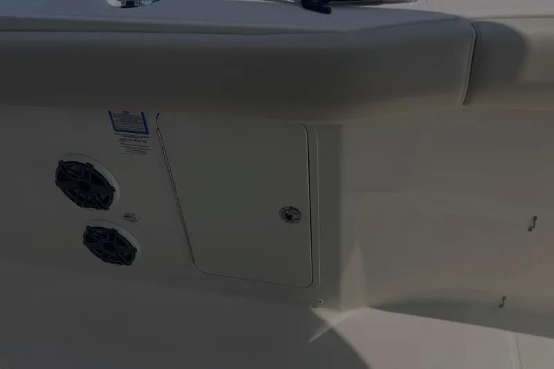 Slide: The Image of 2020 Boston Whaler 350 Realm boat interior with speakers and storage compartment. - 23