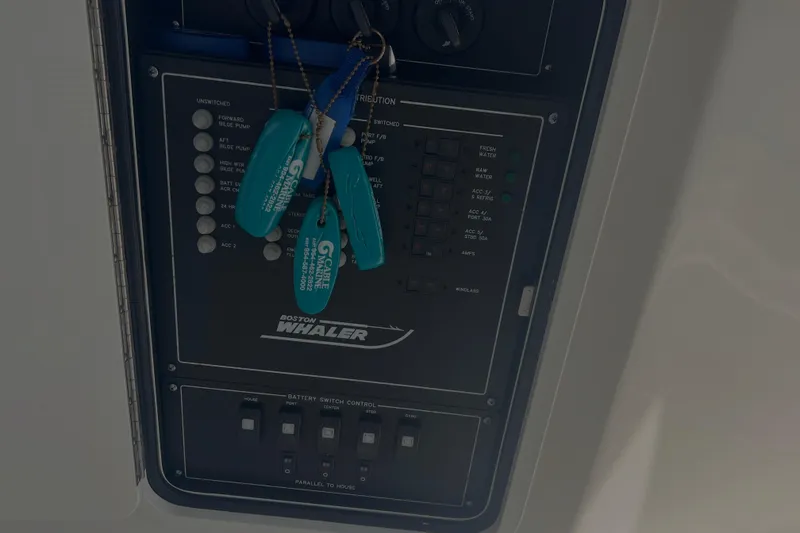 Slide: The Image of Control panel of a 2020 Boston Whaler 350 Realm boat with keychains attached. - 24