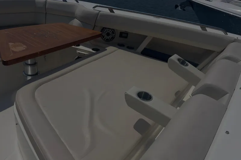 Slide: The Image of Luxurious seating area on 2020 Boston Whaler 350 Realm boat with wooden table. - 25