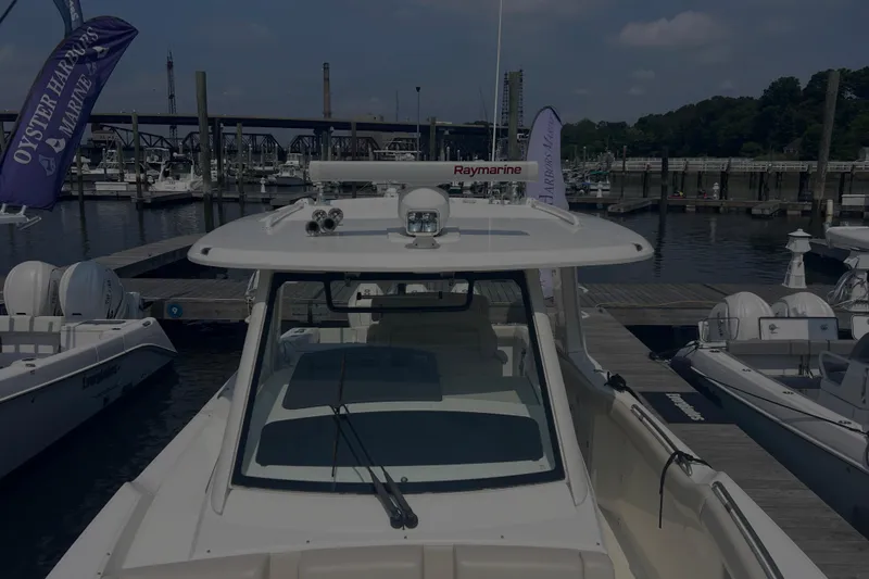 Slide: The Image of 2020 Boston Whaler 350 Realm docked at marina with Raymarine equipment. - 26
