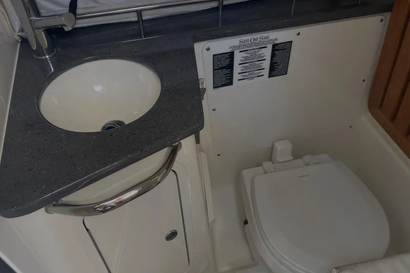 Slide: The Image of 2020 Boston Whaler 350 Realm bathroom with sink and toilet. - 28