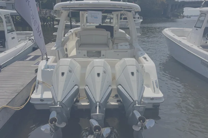 Slide: The Image of 2020 Boston Whaler 350 Realm with triple outboard engines docked at marina. - 3