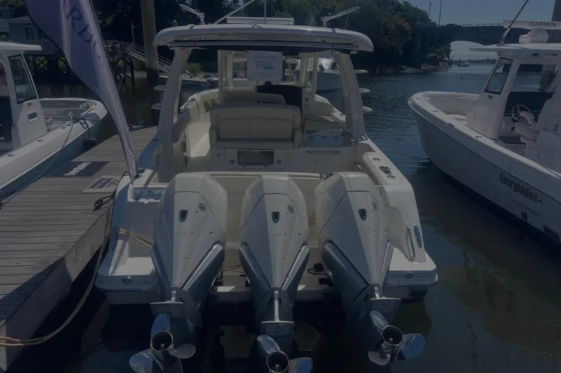Slide: The Image of 2020 Boston Whaler 350 Realm boat docked with triple outboard engines. - 31