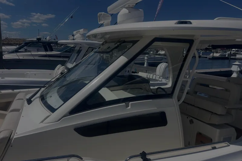 Slide: The Image of 2020 Boston Whaler 350 Realm boat docked at marina under clear blue sky. - 38