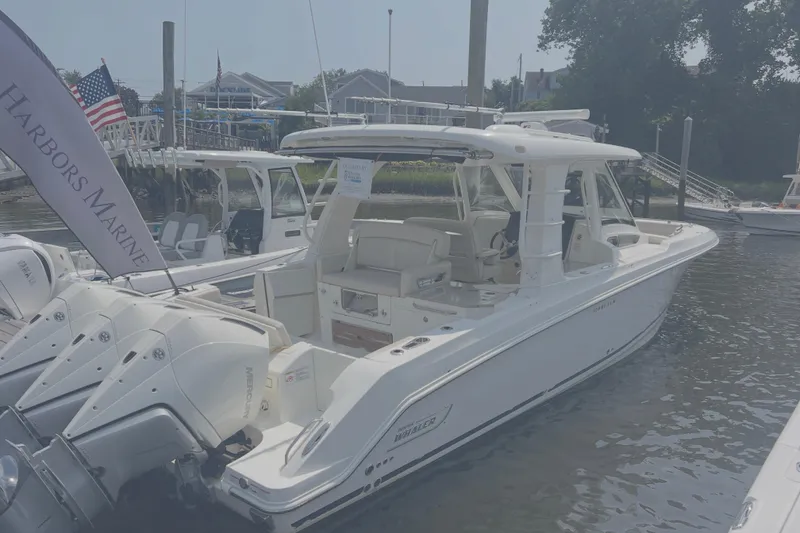 Slide: The Image of 2020 Boston Whaler 350 Realm boat docked at marina with triple outboard engines. - 4