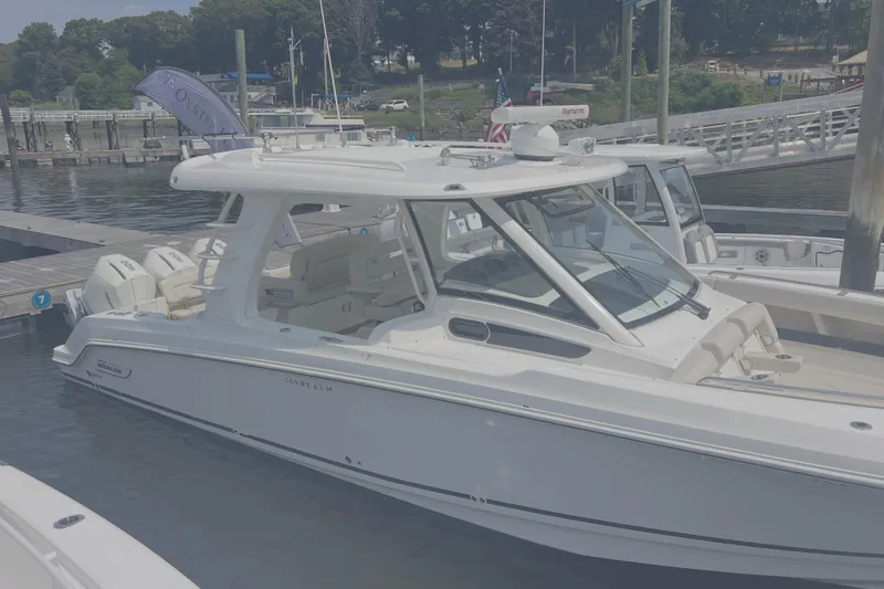 Slide: The Image of 2020 Boston Whaler 350 Realm boat docked at a marina. - 6