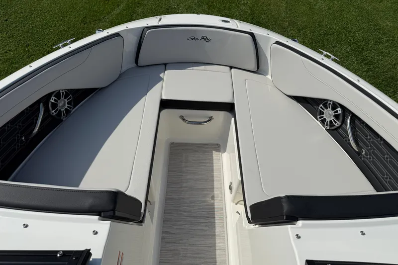 Slide: The Image of 2025 Sea Ray SPX 210 Outboard boat interior with cushioned seating and speakers. - 10