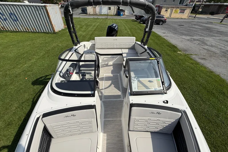 Slide: The Image of 2025 Sea Ray SPX 210 Outboard boat interior with seating and steering console. - 11