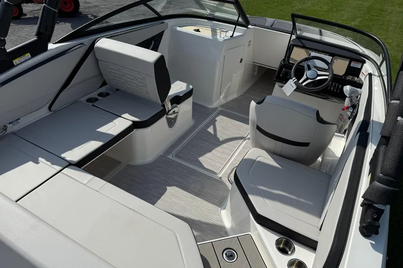 Slide: The Image of 2025 Sea Ray SPX 210 Outboard boat interior with modern seating and steering console. - 4