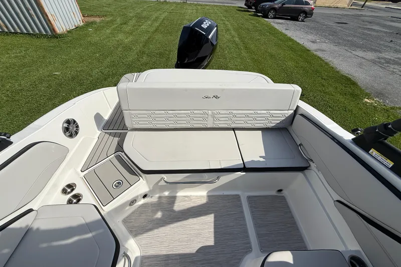 Slide: The Image of 2025 Sea Ray SPX 210 Outboard boat interior with seating and outboard motor. - 6