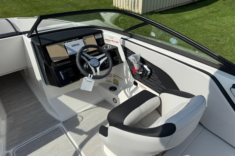 Slide: The Image of 2025 Sea Ray SPX 210 Outboard boat interior with steering wheel and dashboard. - 7