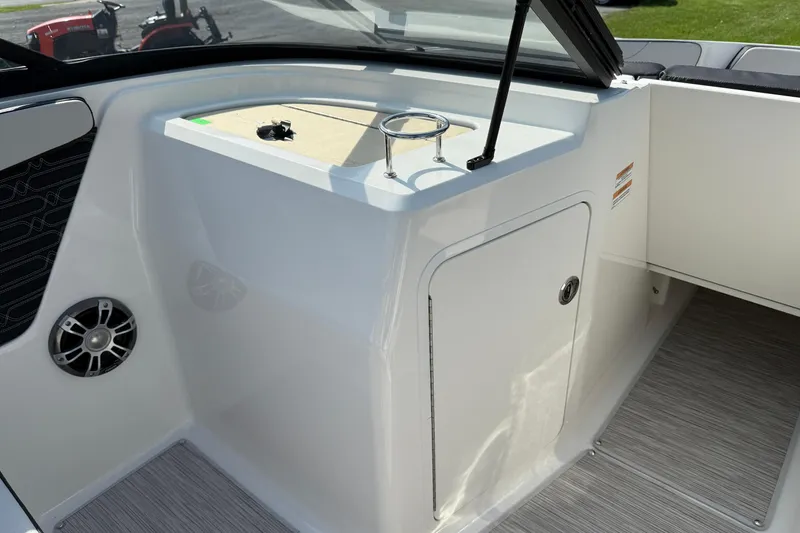 Slide: The Image of 2025 Sea Ray SPX 210 Outboard interior with storage compartment and speaker. - 8