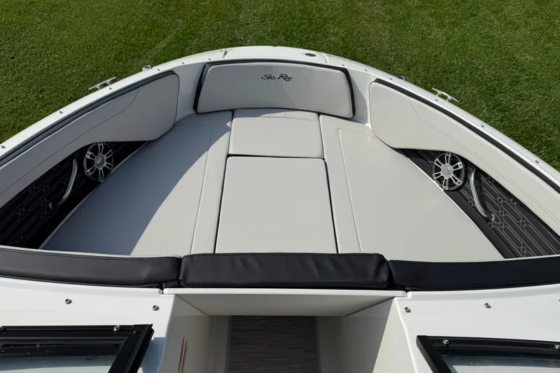 Slide: The Image of 2025 Sea Ray SPX 210 Outboard boat interior with cushioned seating and speakers. - 9