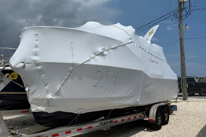The Image of 2025 Ranger Tugs R-25 boat covered in protective wrap on a trailer. - 0