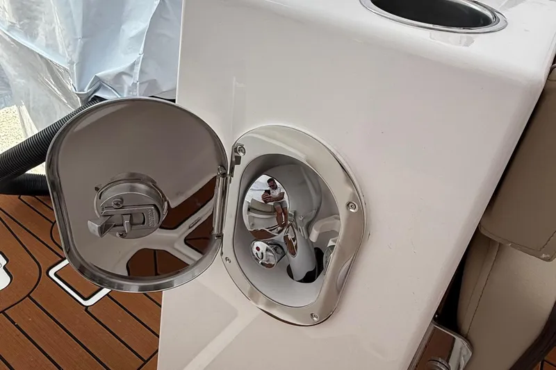 Slide: The Image of Fuel cap on 2025 Ranger Tugs R-25 boat, featuring sleek stainless steel design. - 12