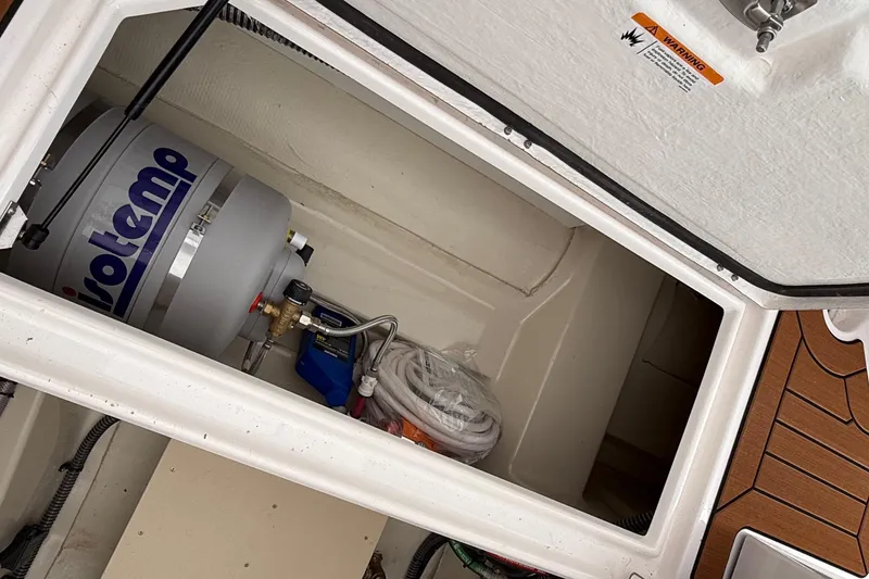 Slide: The Image of Storage compartment of 2025 Ranger Tugs R-25 with Isotemp water heater. - 16