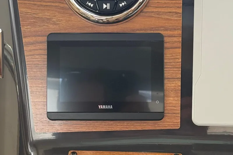 Slide: The Image of Yamaha display on 2025 Ranger Tugs R-25 dashboard with wood paneling. - 22