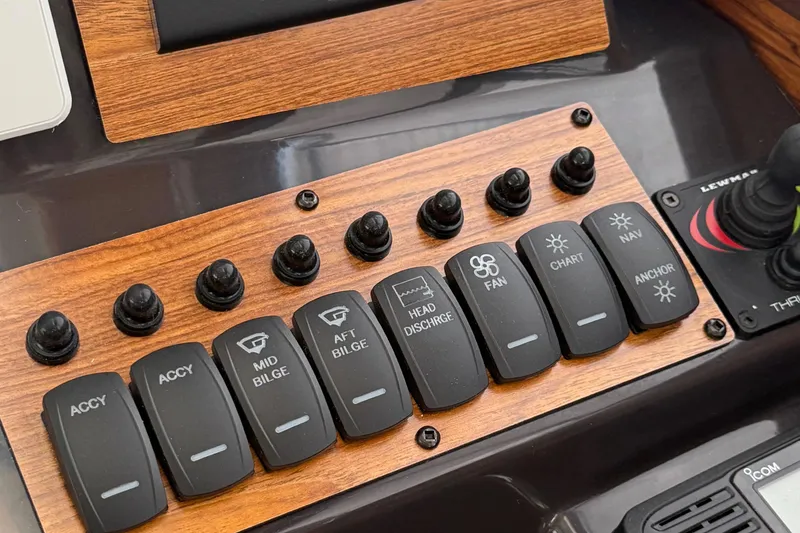 Slide: The Image of Control panel of 2025 Ranger Tugs R-25 boat with labeled switches and joystick. - 24