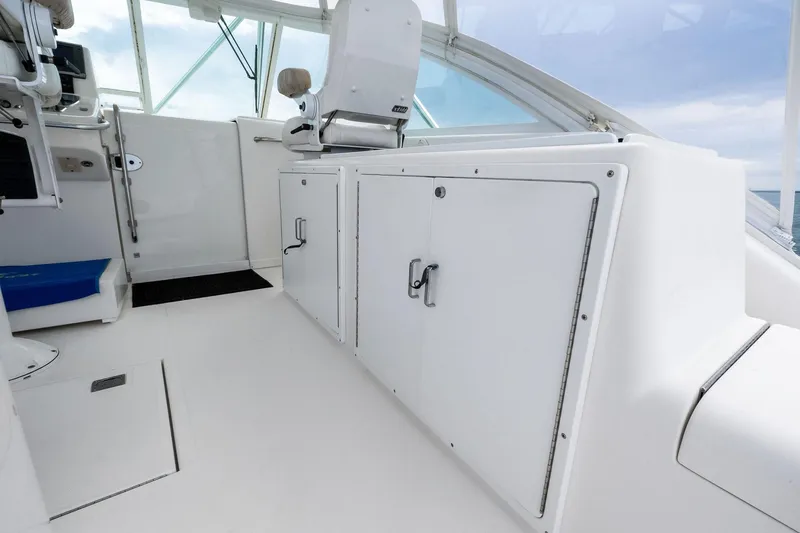 Slide: The Image of 2004 Cabo 40 Hardtop Express interior with white cabinetry and seating. - 10