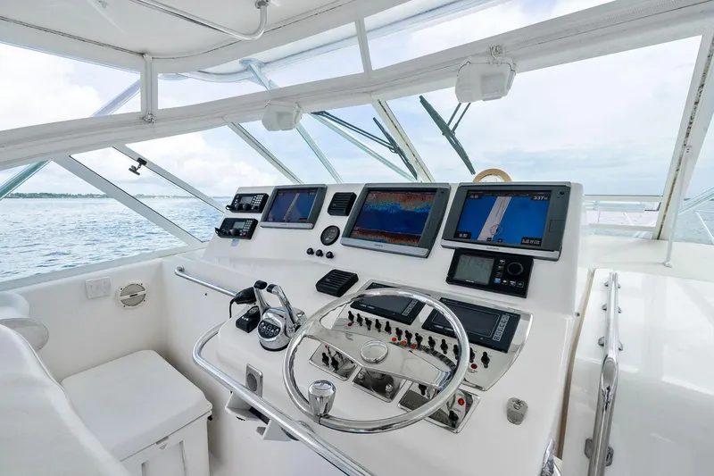 Slide: The Image of Helm of 2004 Cabo 40 Hardtop Express with advanced navigation systems and controls. - 14