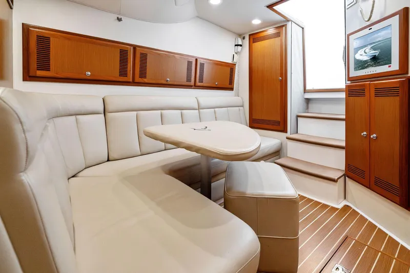 Slide: The Image of Luxurious interior of 2004 Cabo 40 Hardtop Express yacht with plush seating and wooden accents. - 19