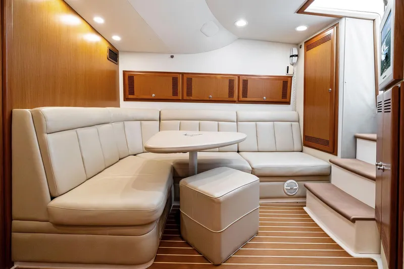 Slide: The Image of Luxurious interior of 2004 Cabo 40 Hardtop Express yacht with plush seating and wooden accents. - 21