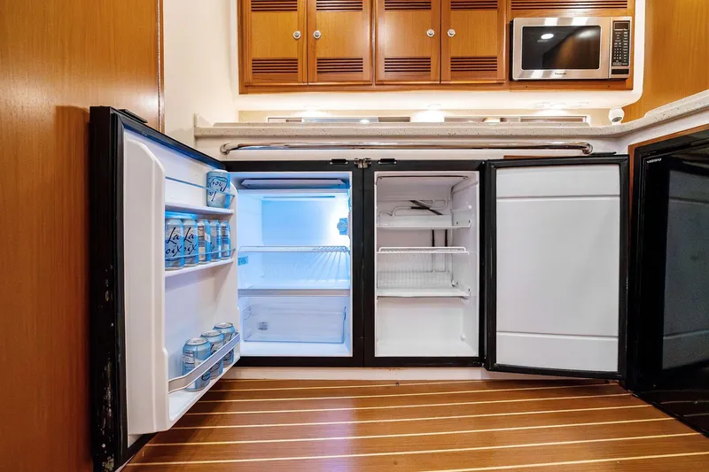 Slide: The Image of Open refrigerator in 2004 Cabo 40 Hardtop Express yacht kitchen, stocked with beverages. - 23