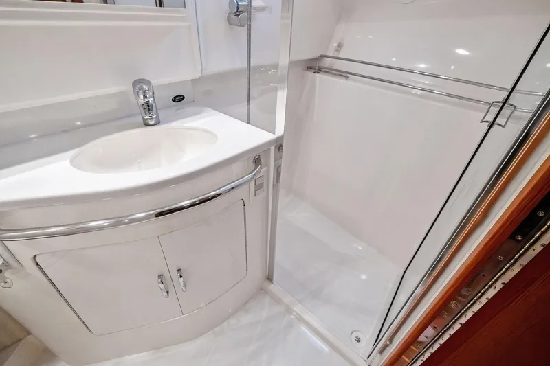 Slide: The Image of 2004 Cabo 40 Hardtop Express bathroom with sink and shower enclosure. - 27