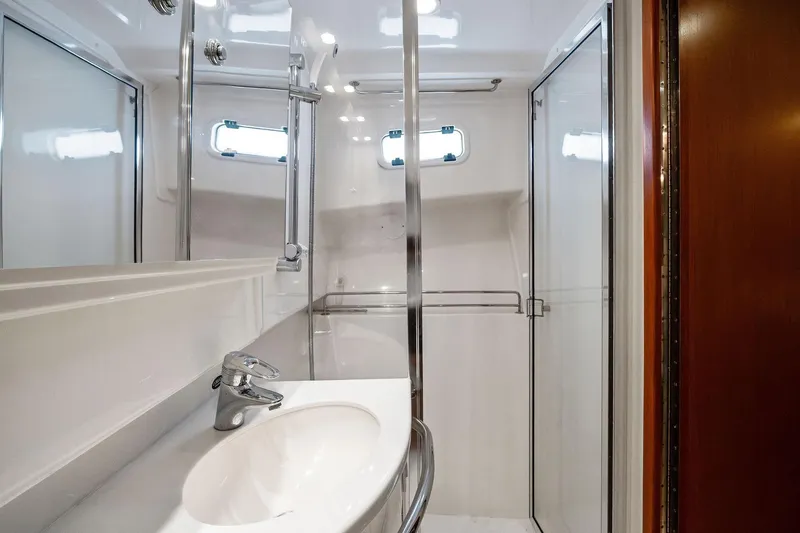 Slide: The Image of Luxurious bathroom in 2004 Cabo 40 Hardtop Express yacht with modern fixtures and shower. - 28