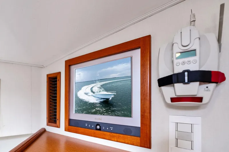 Slide: The Image of Interior of 2004 Cabo 40 Hardtop Express with wall-mounted TV and control panel. - 31