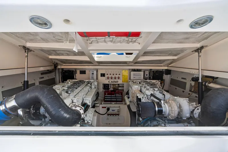 Slide: The Image of Engine room of 2004 Cabo 40 Hardtop Express with dual engines and mechanical components. - 33