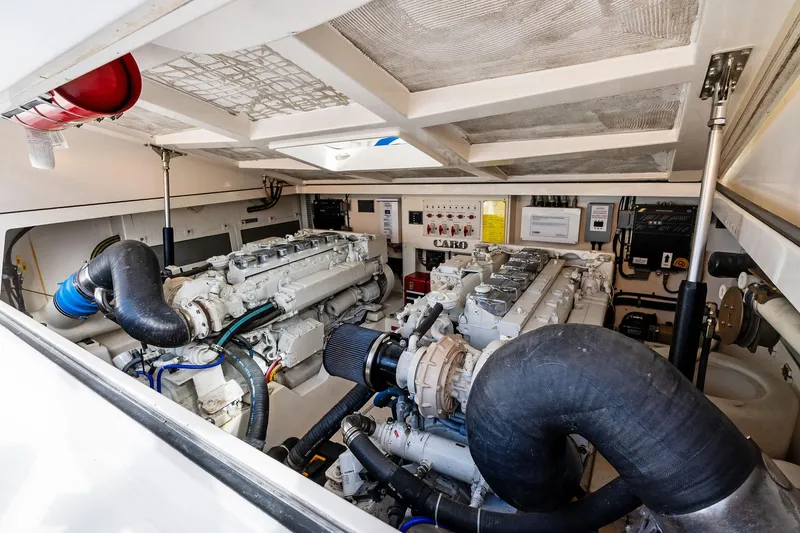 Slide: The Image of Engine room of 2004 Cabo 40 Hardtop Express with dual engines and control systems. - 34