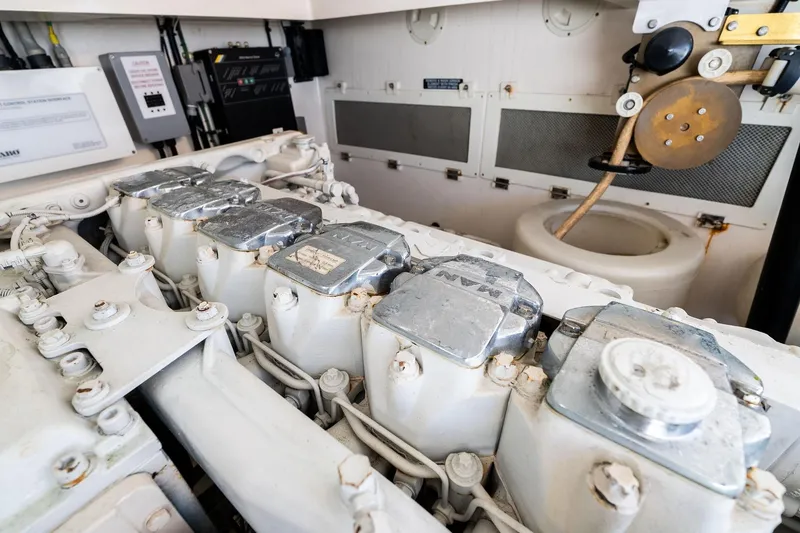 Slide: The Image of Engine room of a 2004 Cabo 40 Hardtop Express boat, showcasing mechanical components. - 38