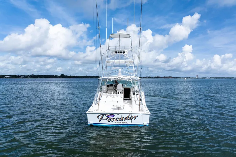 Slide: The Image of 2004 Cabo 40 Hardtop Express boat on open water under a blue sky. - 4